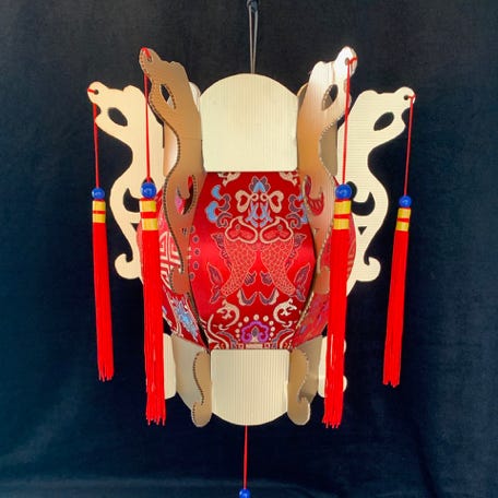 A Chinese-style lantern with red brocade, gold trim and tassles.