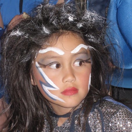 A girl with wild hair and stylised makeup