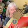 Calico director Jenny Wake holding a colourful costume hat